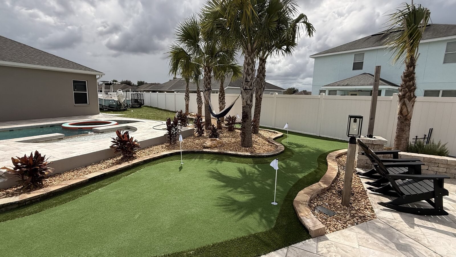 Putting green com piscina e deck de pavers na Fl&oacute;rida Central