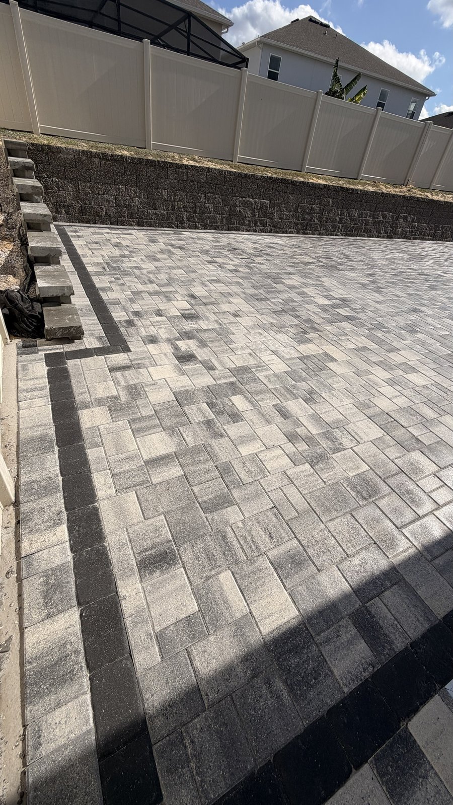 Retaining wall with paver patio and steps, Central Florida backyard